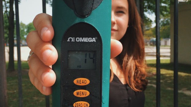 Woman holding leadpipe tester