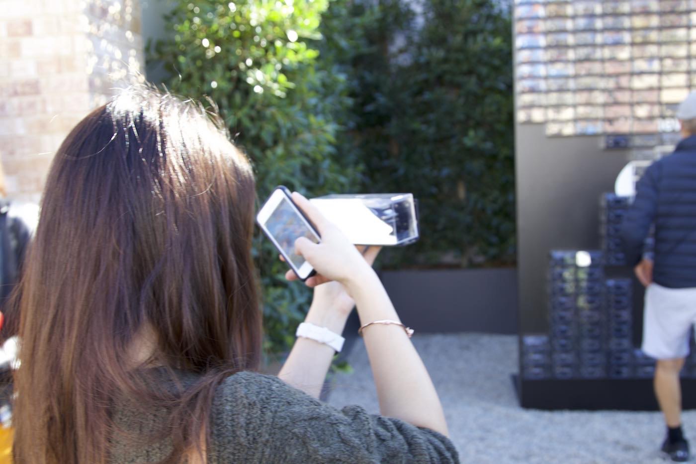 Woman sharing Cayenne miniture model on social